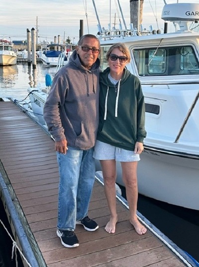 Emily Kmosko and her fiance are on a dock, smiling.